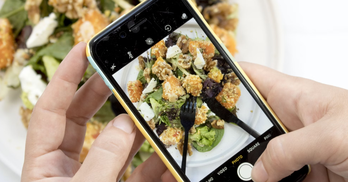 nutrition content ideas for dietitians, photo of a health and wellness influencer taking a photo of a healthy bowl of food with an iphone
